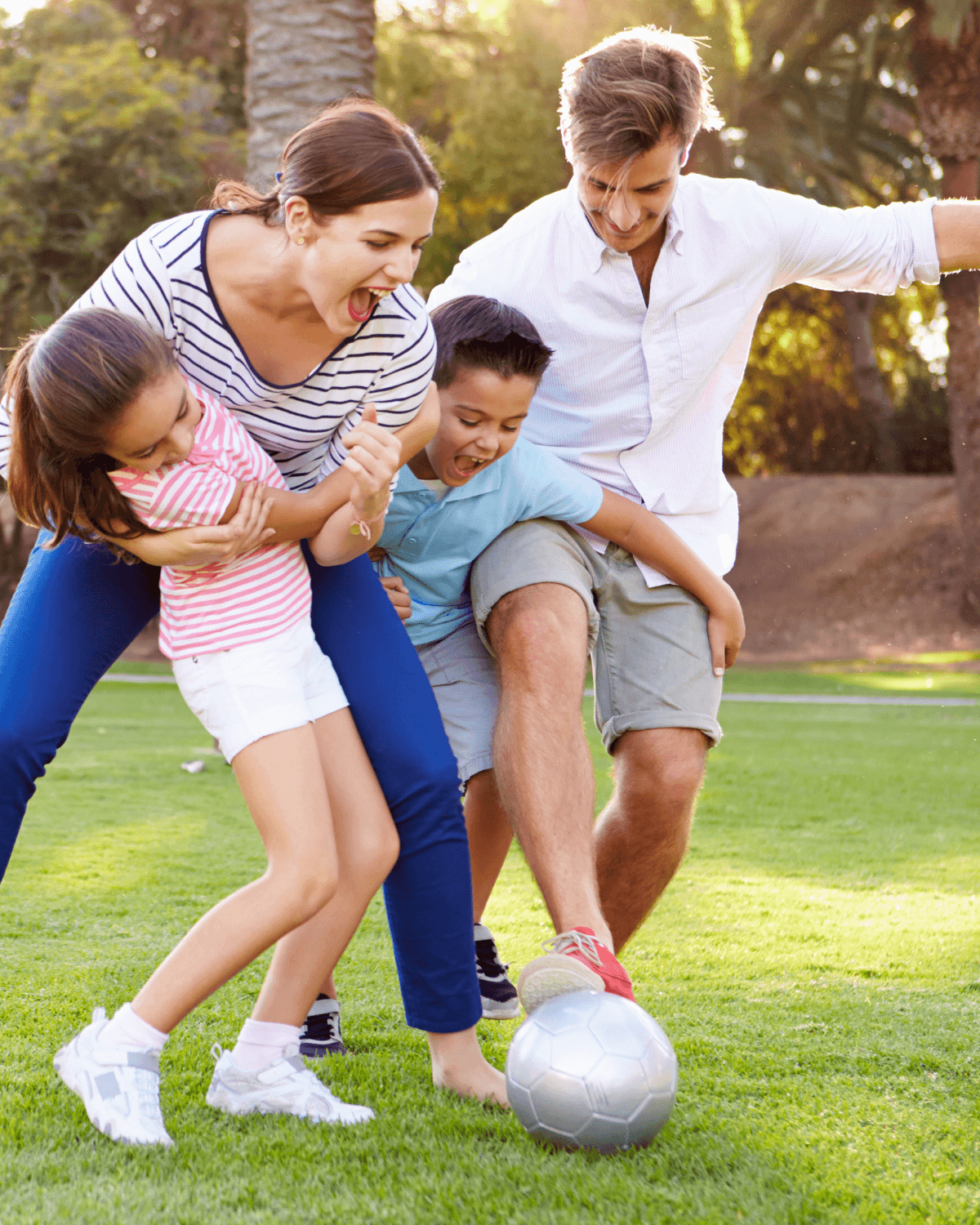 A happy family playing together outdoors, covered by CoverageCo