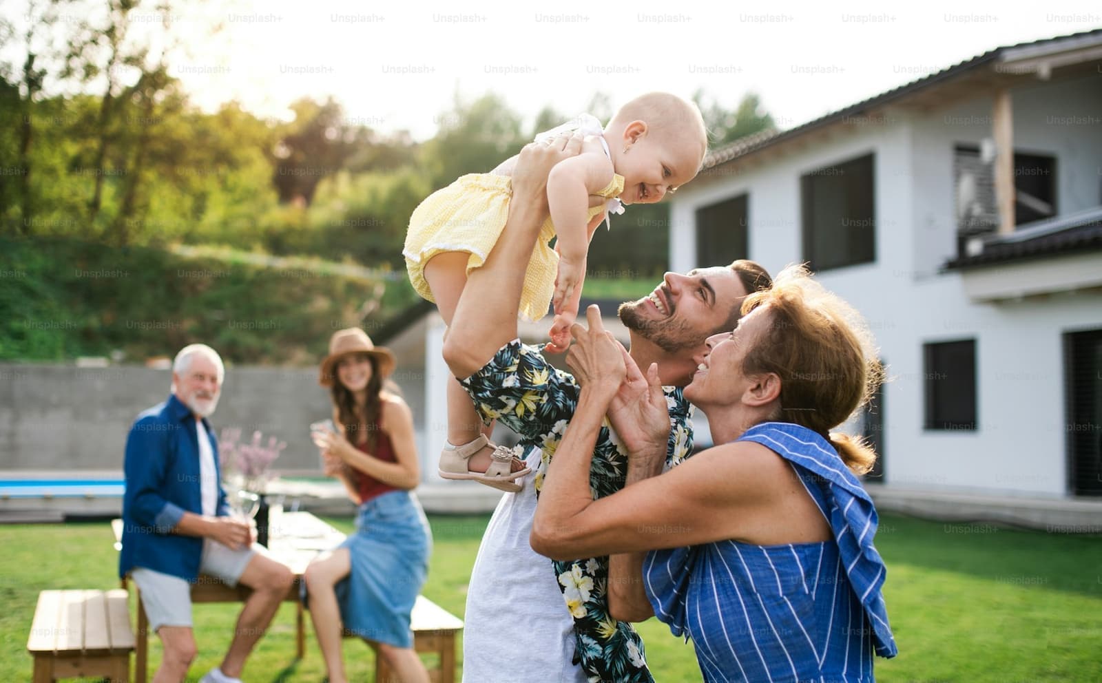 Three generations of a family playing together in a backyard